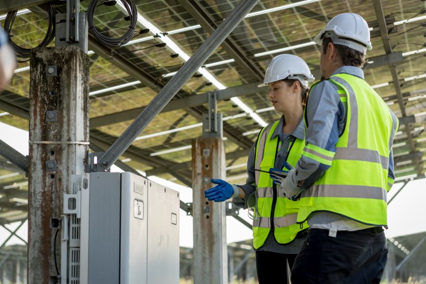 Solar engineers inspecting inverter system for residential solar installation in Massachusetts