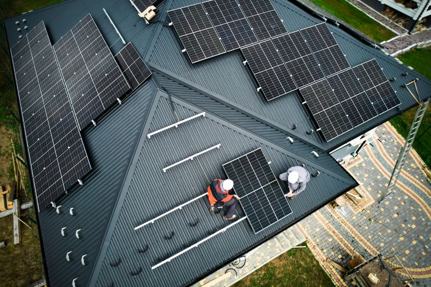 EcoSunWorks installing black solar panels on a residential rooftop