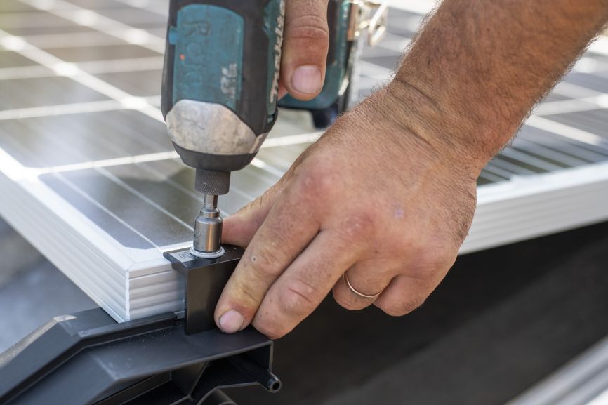 Eco Sun Works team mounting off-grid solar panels on a residential rooftop
