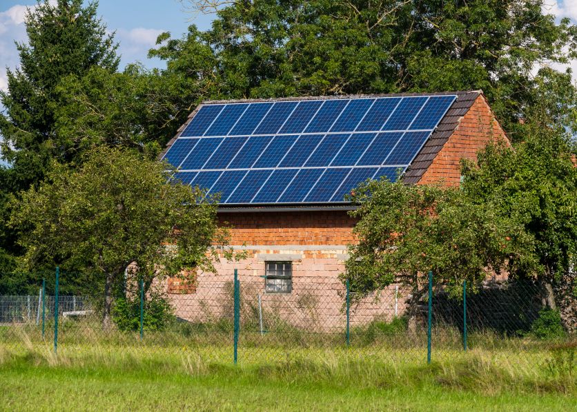 house with solar roof panels and carport solar shades