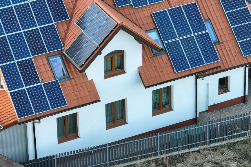 Off-grid home with solar panels in a rural setting.