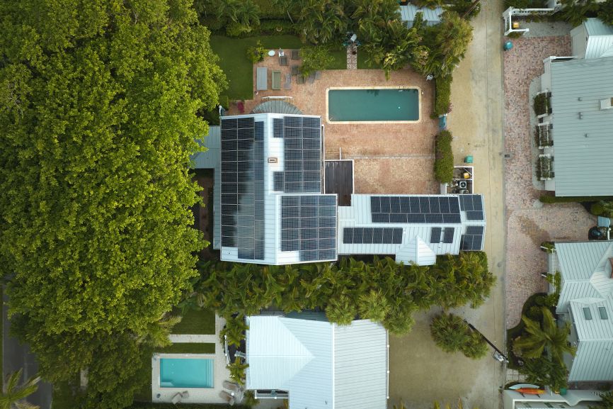 Aerial view of a modern home equipped with a 4000 watt solar panel system by EcoSunWorks in Massachusetts.