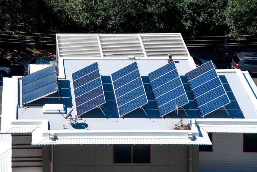 Flat roof solar installation by EcoSun Works showing the best orientation for solar panels to achieve maximum sunlight exposure and energy efficiency.