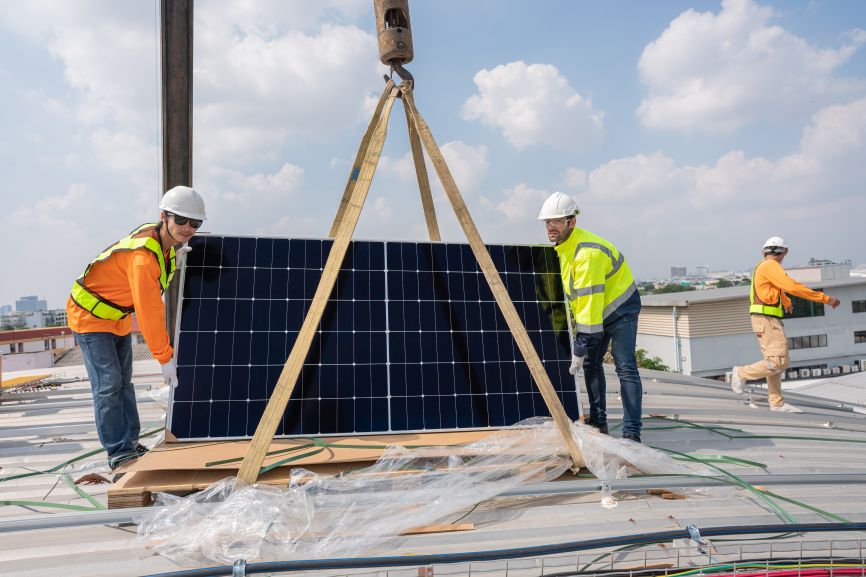 EcoSunWorks technicians installing rooftop solar panels — demonstrating safe handling and setup for the topic “How Much Do Solar Panels Weigh?”