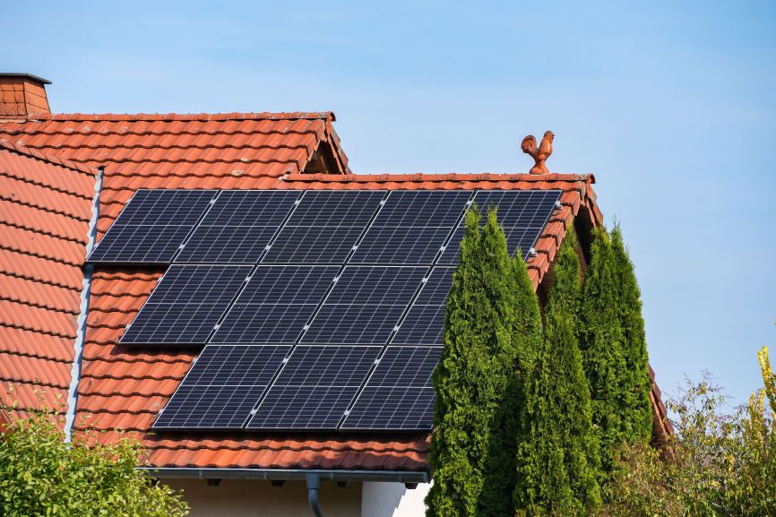 EcoSunWorks solar panels installed on a red-tiled residential roof, illustrating the topic “How Much Do Solar Panels Weigh?” and roof strength for solar systems.