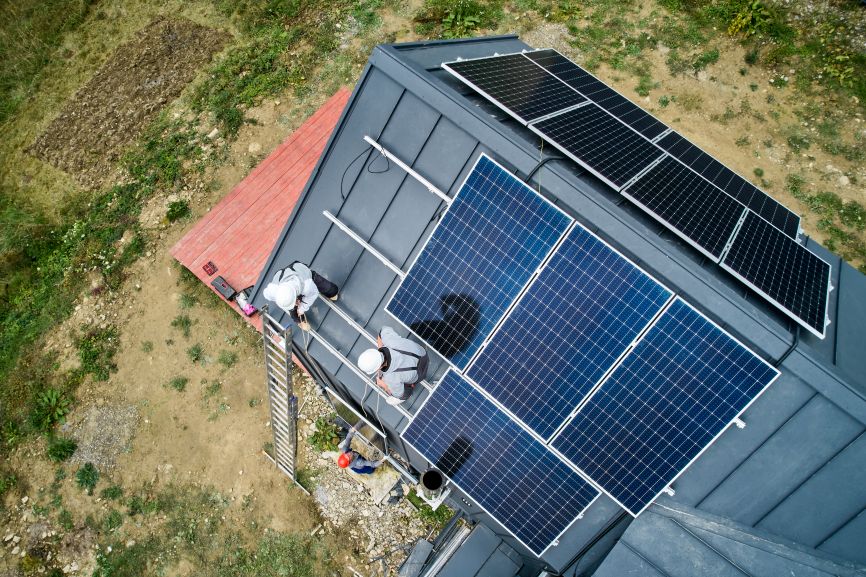 Technicians removing solar panels from roof — showing who can remove solar panels from roof safely with EcoSunWorks experts.
