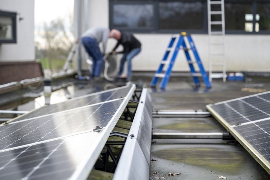 Technicians performing maintenance and removal work on solar panels — showing who can remove solar panels from roof safely with EcoSunWorks.