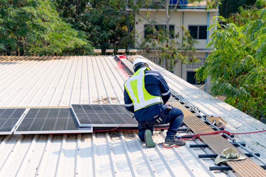 EcoSunWorks technician safely removing solar panels from roof — showing who can remove solar panels from roof with professional care.