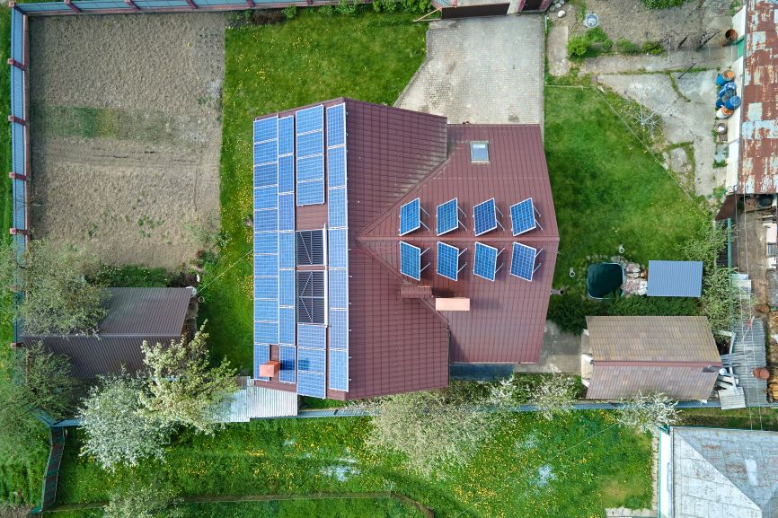Does a solar panel give off any fumes – EcoSunWorks aerial view of a Massachusetts home with rooftop solar panels producing clean, safe energy